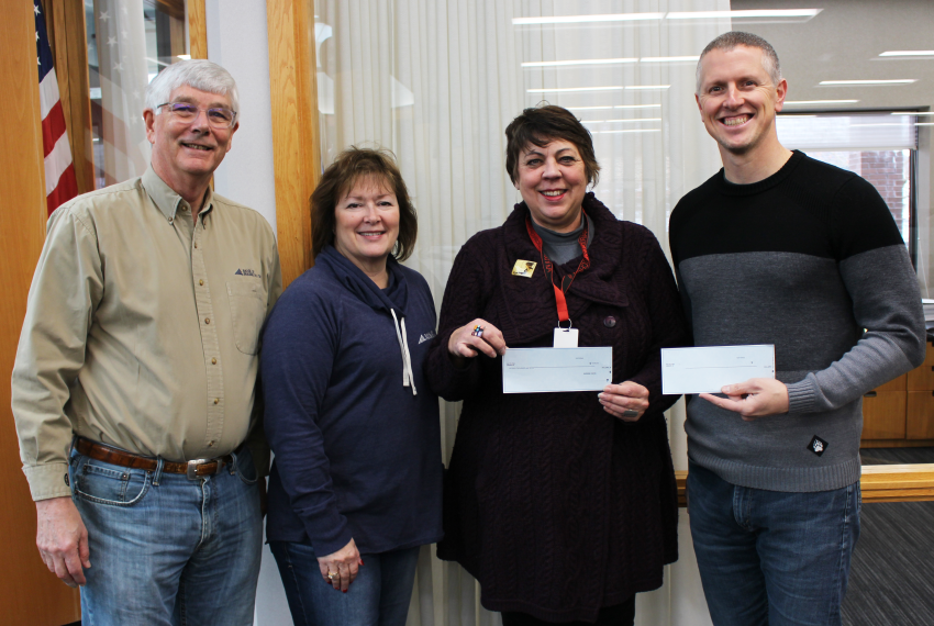 Two People Holding Check