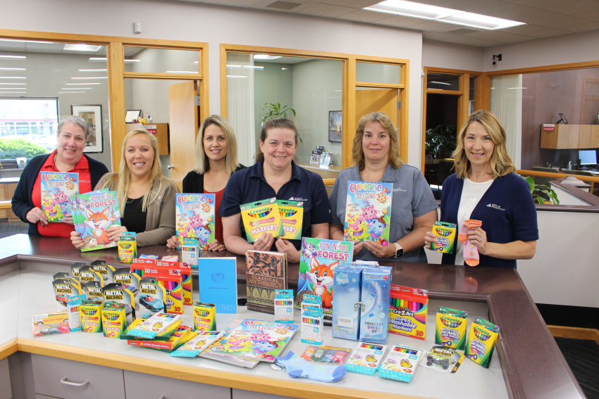 Group of People Holding Check