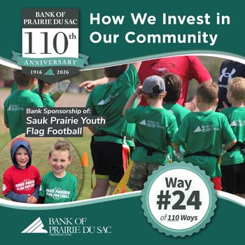 Sauk Prairie youth flag football, children in huddle with coach, bank logo is on back of t-shirts.