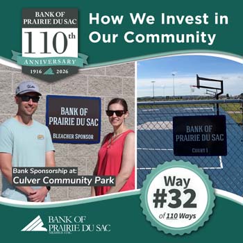 Way #32 - Bank Staff by signage noting bank's sponsorship of bleachers at baseball diamond and basketball court.